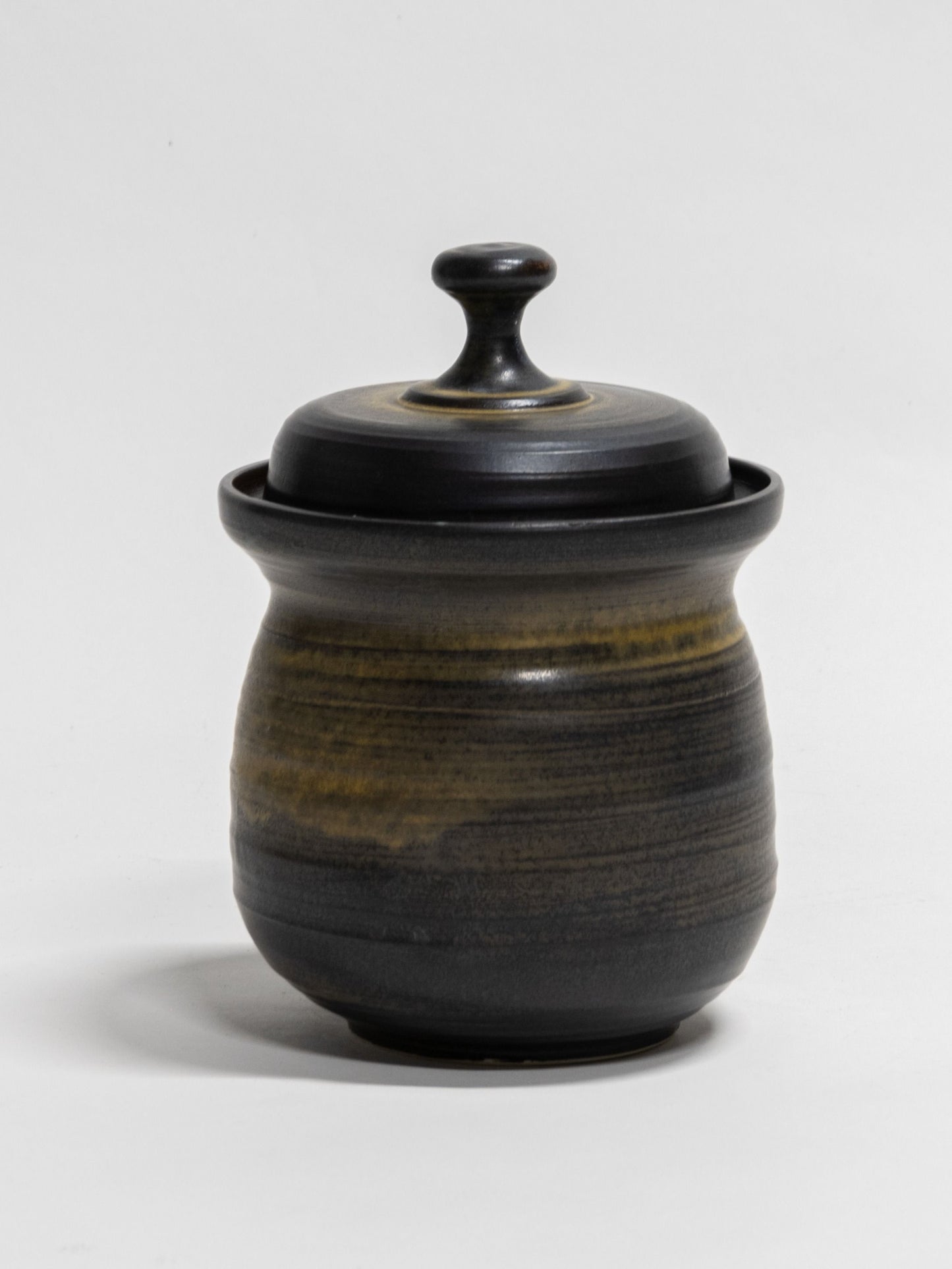 A ceramic fermentation pot with a lid, in a matte black glaze. Handmade in Australia at Valla Beach NSW. 